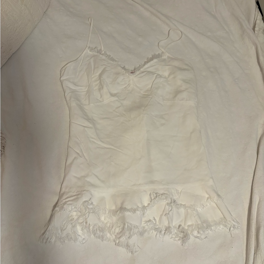White mini dress. Not sure of size but it fits me and I’m usually a medium